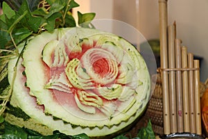 Carved fruit of watermelon to flower form and green leaves.