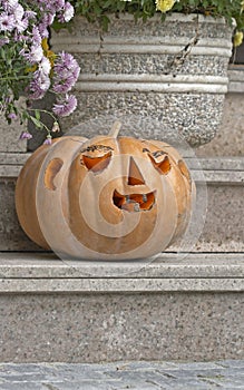  Carved Halloween pumpkin on a house ladder 