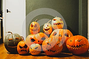 Carved halloween pumpkins on green background.