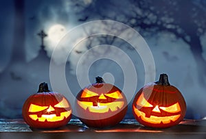 Carved lightening pumpkins for Halloween jack-o\'-lanterns with scary smiles to ward of evil spirits