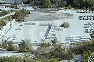 Carved marble blocks ready for spedition on large square, Carrara, Italy