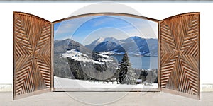 Carved open double door with view to lake and the alps