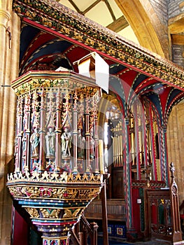 Carved and painted wooden pulpit and rood screen in medieval English church, UK photo