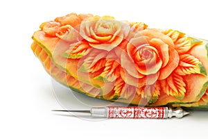Carved papaya fruit and knife