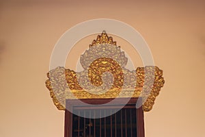 Carved pattern of the lintel above the window of Buddhist temple hall in Phnom Penh