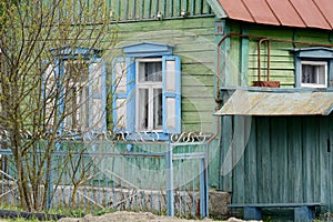 Carved platbands and shutters on the windows. Beautiful windows in old, abandoned houses