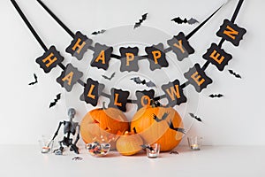 Carved pumpkins with candies and halloween garland