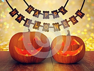 Carved pumpkins and happy halloween garland