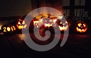Carved pumpkins lit up on the porch