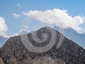 Carved rocks aligned with background mountains in Machu Picchu Ruins, Cusco,