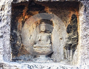 A carved stone Buddha, carved from the rock, Longmen Grottoes an