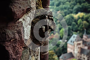Carved stone face adorns the exterior of a building, a striking architectural feature