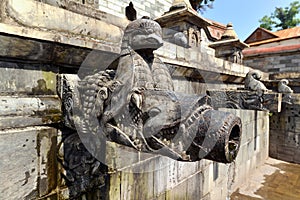 Carved stone public fountain. Pashupatinath, Nepal