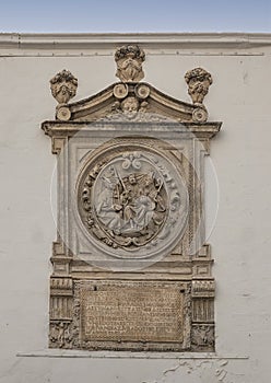 Carved stone relief above the Postigo del Aceite in Seville, Andalusia, Spain.