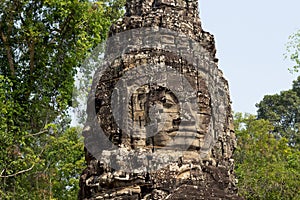 Carved tower bas-relief of Angkor Wat complex temple, Siem Reap, Cambodia. Buddha face stone carving