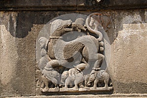 Carved wall showing a sharabha lifting elephants in its bare paws. Dakshin Kashi Mandir. Mahuli Sangam. Satara. Maharashtra photo