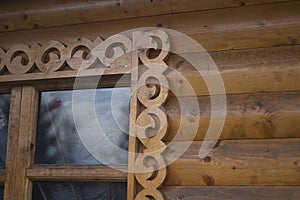 Carved window frame.  Wooden tweeter in the hut.  Old era window.