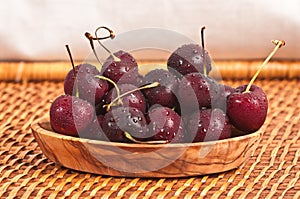 Carved wood bowl of cherries