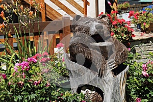 Carved wooden bear statue in a garden in Verres in Val D\'Aosta-Italy.