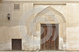 Carved wooden door and ornate doorway in Bahrain
