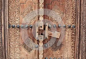 Carved wooden door and ornate doorway in Bahrain