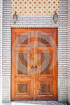 carved wooden doors with Uzbek carved pattern with Islamic ornament in oriental style in Uzbekistan