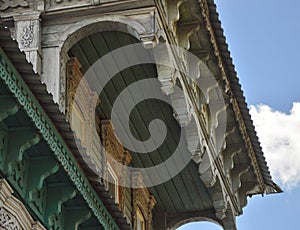 A carved wooden house a detail of the roof