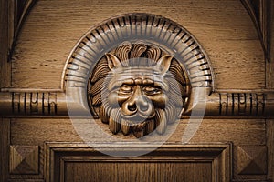 Carved wooden lion head on the door