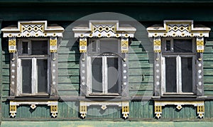 Carved wooden platbands on windows of old wooden house, Kostroma, Russia