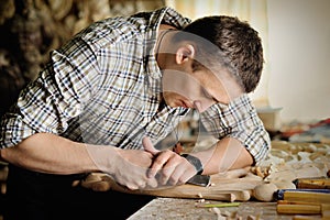 Carver in workshop of wood carving