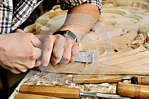 Carvers Hands work with chisel in workshop