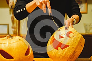 Carving halloween pumpkins in the kitchen.