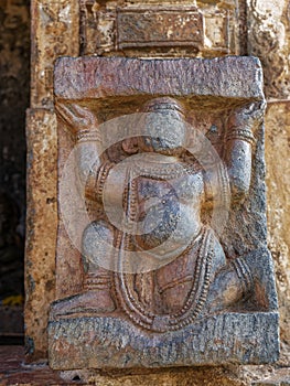 Carving of a man carrying a load carving on the wall