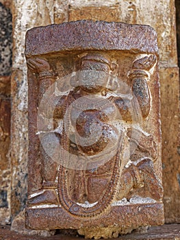 Carving of a man carrying a load carving on the wall