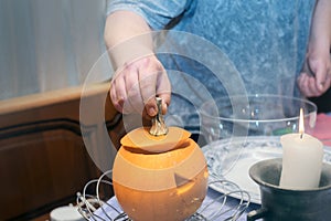 carving raw halloween pumpkin