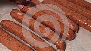 carving raw sausages with knife