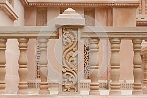 Carving on red stone railing