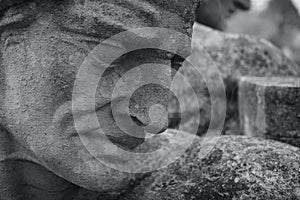 Carving in stone of a male head in a group of public statues in Cardiff Wales