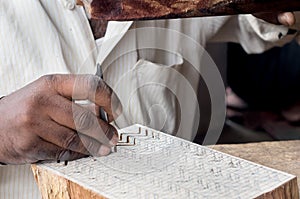 Carving a wooden printing block for textile block printing