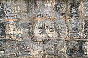 Carvings along the wall of the Tzompantli (Temple of the Skulls) in Chichen Itza