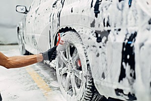 Carwash service, washing of wheels with brush