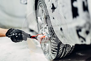 Carwash service, washing of wheels with brush