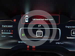 The carâ€™s LCD dashboard displays a warning that the front left door is open