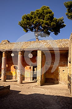 Casa della Gemma in Ercolano with columns. Ruins of ancient roman town Ercolano - Herculaneum, destroyed by eruption of Vesuvius