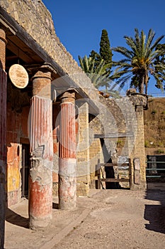 Casa della Gemma in Ercolano with columns. Ruins of ancient roman town Ercolano - Herculaneum, destroyed by eruption of Vesuvius