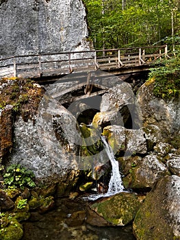 Cascade falls over mossy rocks at the Myrafaelle (myrafalls) hiking trail