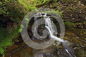 Cascade of water over the rocks in a small beck