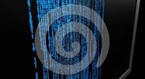 cascading binary code on a dark computer screen
