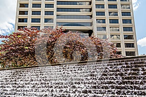 Cascading Fountain Under Tree and Building