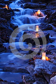 Cascading waterfall with candles